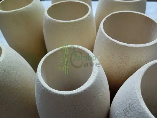 A bamboo beer glass is a unique blend of sustainability, craftsmanship, and natural elegance. Made from carefully selected mature bamboo, each glass is handcrafted to preserve the natural grain patterns and organic texture, giving every piece a distinct character. The outer shell retains the authentic look of bamboo, while the inner portion is often treated or fitted with a food-safe lining to ensure hygiene and durability. This makes it suitable for serving chilled beer while maintaining the earthy aesthetic that bamboo is known for. Lightweight yet sturdy, bamboo beer glasses are eco-friendly alternatives to traditional glassware. They are biodegradable, renewable, and align perfectly with sustainable living practices. The natural insulation property of bamboo also helps in keeping beverages cool for a longer time. Perfect for cafes, eco-resorts, themed bars, or home décor, bamboo beer glasses add a rustic charm and a touch of nature to any setting. Whether used for serving or display, they stand out as a symbol of creativity and environmentally conscious design.