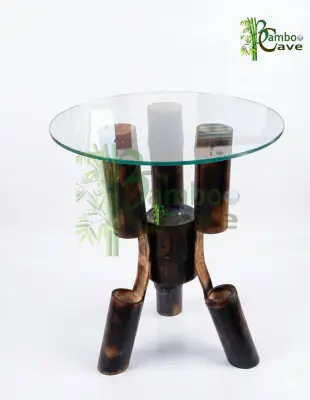 This unique bamboo centre table is a striking blend of craftsmanship and contemporary design. Carefully created using bending bamboo works, the structure showcases the natural strength and flexibility of bamboo, shaped into smooth, flowing forms that support a sleek circular glass top. The rich, charred finish enhances its texture, giving the piece a bold yet earthy character. Crafted from natural eco-friendly materials, this table is not only sustainable but also durable, making it a perfect addition to modern and rustic interiors alike. Its clean lines and artistic structure bring aesthetic looks that effortlessly elevate any living space. This piece is currently a prototype, and customisation is available to suit your space, size, and design preferences. Presented by BAMBOO CAVE team – where innovation meets nature.