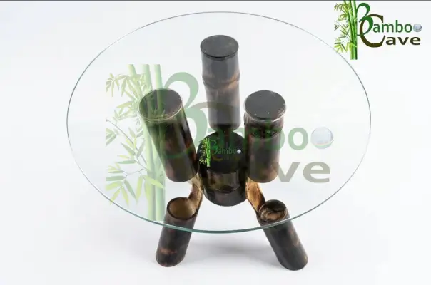 This unique bamboo centre table is a striking blend of craftsmanship and contemporary design. Carefully created using bending bamboo works, the structure showcases the natural strength and flexibility of bamboo, shaped into smooth, flowing forms that support a sleek circular glass top. The rich, charred finish enhances its texture, giving the piece a bold yet earthy character. Crafted from natural eco-friendly materials, this table is not only sustainable but also durable, making it a perfect addition to modern and rustic interiors alike. Its clean lines and artistic structure bring aesthetic looks that effortlessly elevate any living space. This piece is currently a prototype, and customisation is available to suit your space, size, and design preferences. Presented by BAMBOO CAVE team – where innovation meets nature.