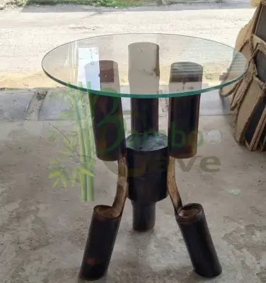 This unique bamboo centre table is a striking blend of craftsmanship and contemporary design. Carefully created using bending bamboo works, the structure showcases the natural strength and flexibility of bamboo, shaped into smooth, flowing forms that support a sleek circular glass top. The rich, charred finish enhances its texture, giving the piece a bold yet earthy character. Crafted from natural eco-friendly materials, this table is not only sustainable but also durable, making it a perfect addition to modern and rustic interiors alike. Its clean lines and artistic structure bring aesthetic looks that effortlessly elevate any living space. This piece is currently a prototype, and customisation is available to suit your space, size, and design preferences. Presented by BAMBOO CAVE team – where innovation meets nature.